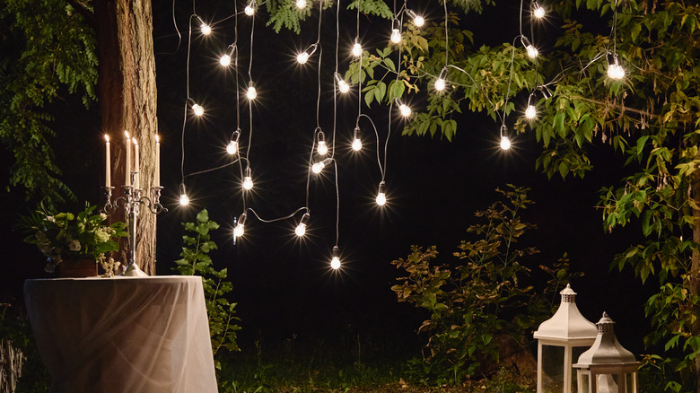 Night,Wedding,Ceremony,With,Candles,,Lanterns,And,Bulb,Lights,On