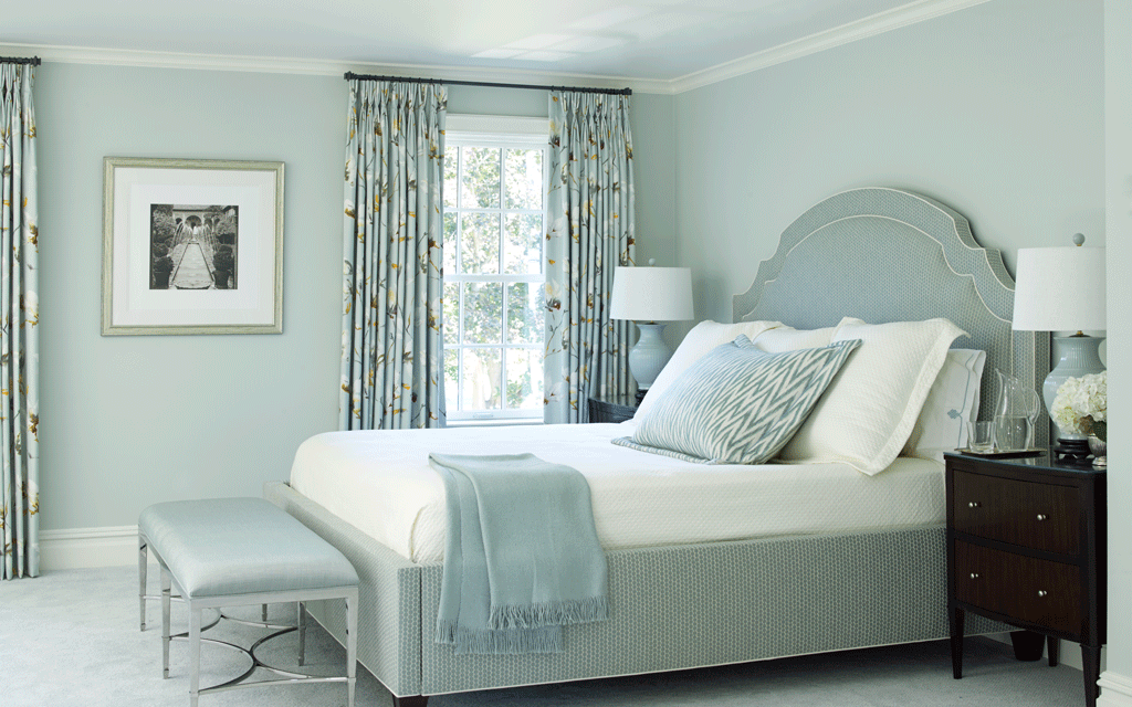 A bedroom with a bed, dresser, nightstand, and window. The room is decorated in Beacon Gray.