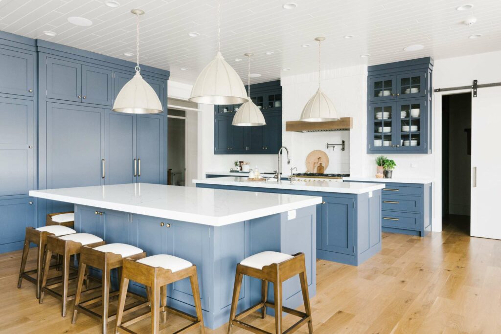 Evening Dove: A spacious kitchen featuring blue cabinets and white countertops