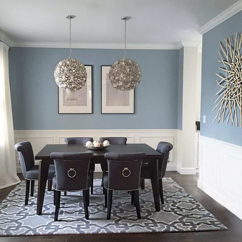 A dining room with blue walls and gray chairs, complemented by the soothing shade of Nimbus Gray