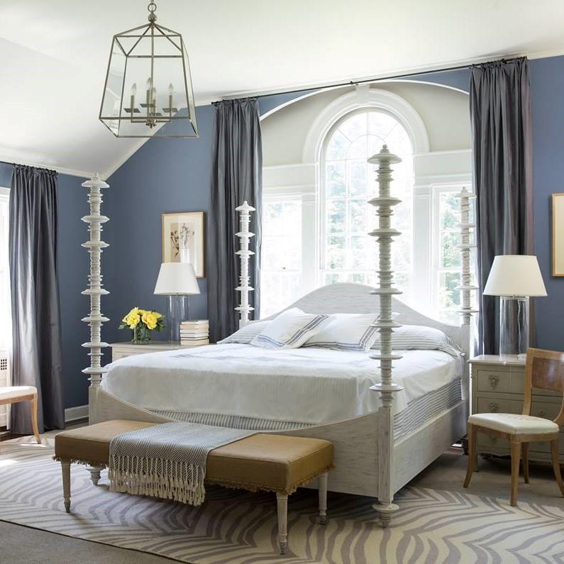 A bedroom with blue walls and white furniture, featuring Oxford Gray accents