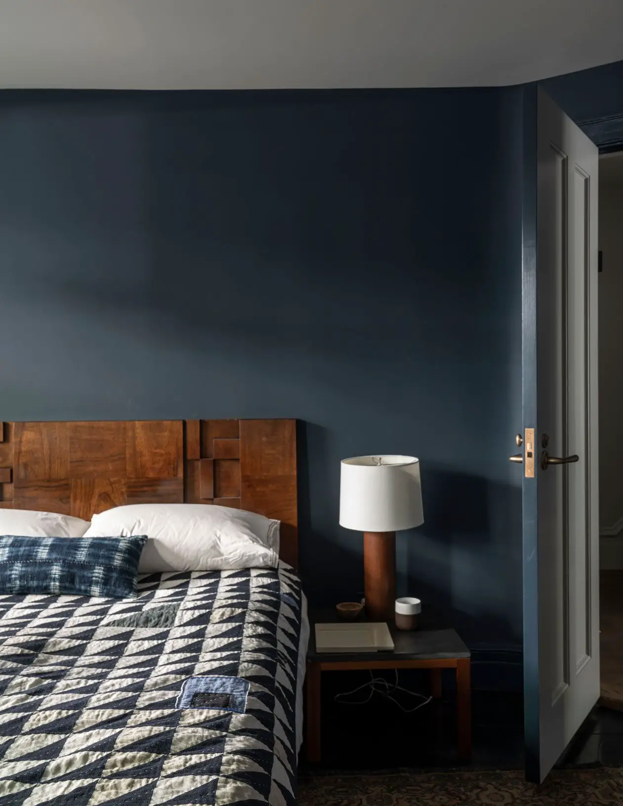 A cozy bedroom with blue walls and a bed, adorned with Raccoon Fur for added warmth and comfort
