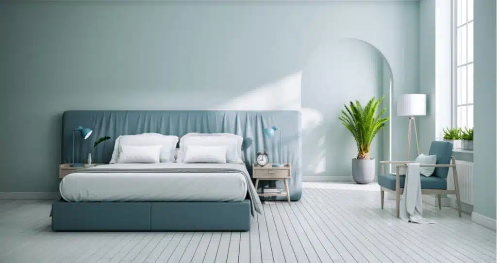 smoke-free clean bedroom with serene blue walls and pristine white floors.