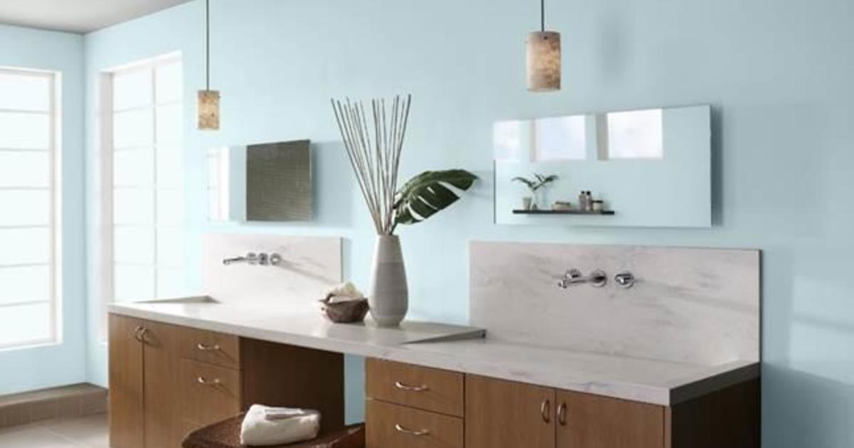 A bathroom with blue walls and white counter tops. Expert tips on using LRV for paint colors