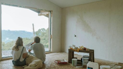 A couple of people sitting on the floor in a room with a large window AI-generated content may be incorrect.