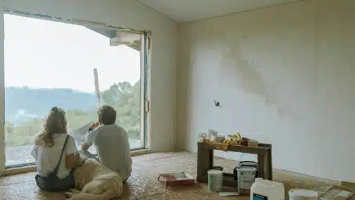 A couple of people sitting on the floor in a room with a large window AI-generated content may be incorrect.
