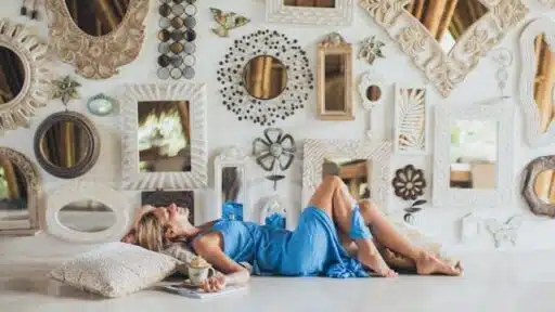 women lying on the floor near wall mirrors.