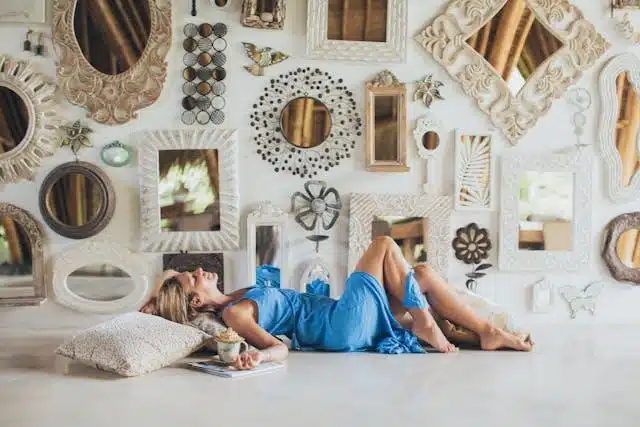 women lying on the floor near wall mirrors.