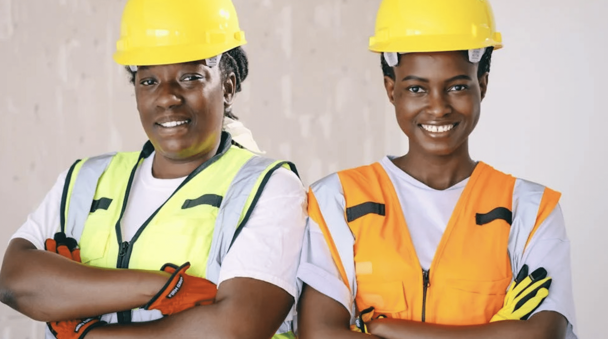 two female construction workers smiling confidently