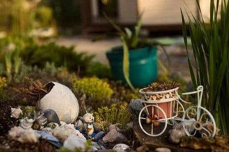 small garden decorations in a flowerbed