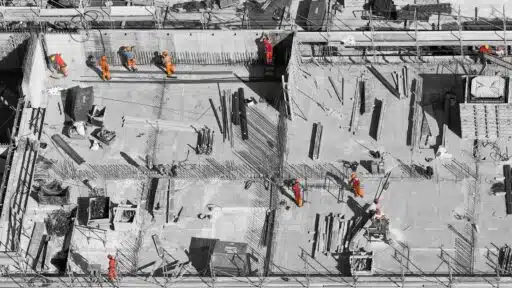 Heavy-duty construction trash chute solutions installed on scaffolding for safe and efficient debris removal.