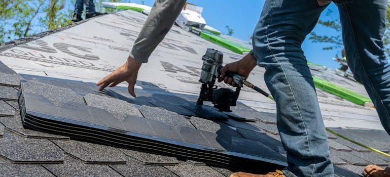 a man fixing the roof after moving into a fixer-upper