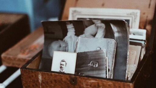 A vintage brown wooden box with black and white photos.