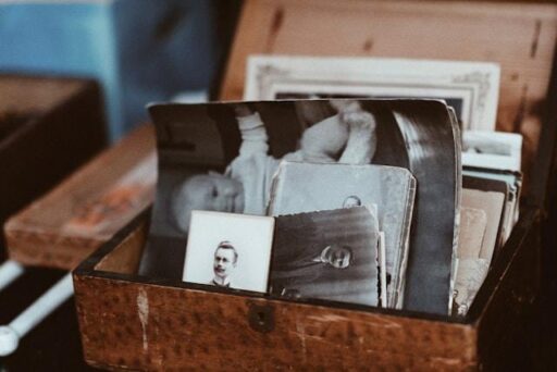 A vintage brown wooden box with black and white photos.
