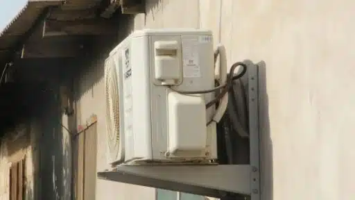 a white phone mounted to the side of a building