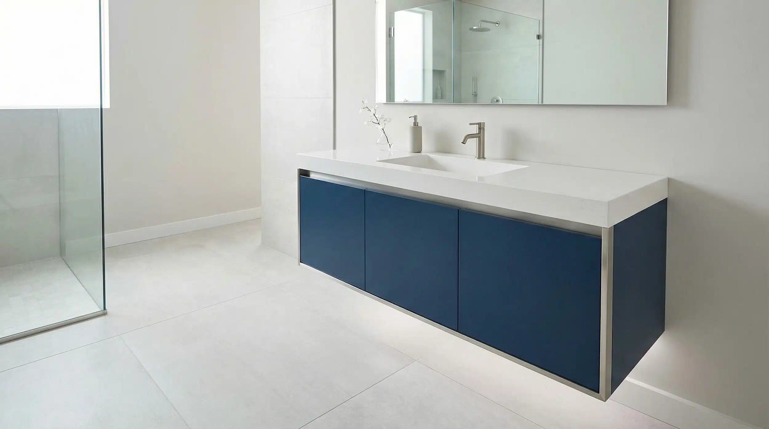 Shows the floating, slab-front navy vanity with visible floor space, making the ‘spacious feel’ benefit instantly clear.