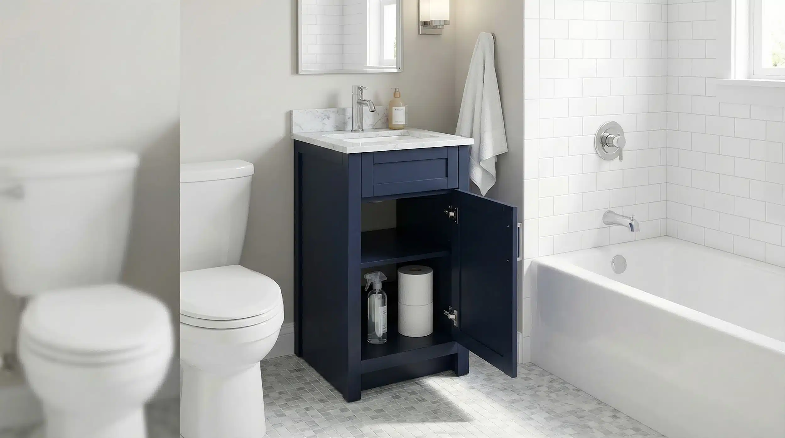 Visually demonstrates how a narrow navy vanity fits between toilet and tub, helping small-space readers picture the layout.