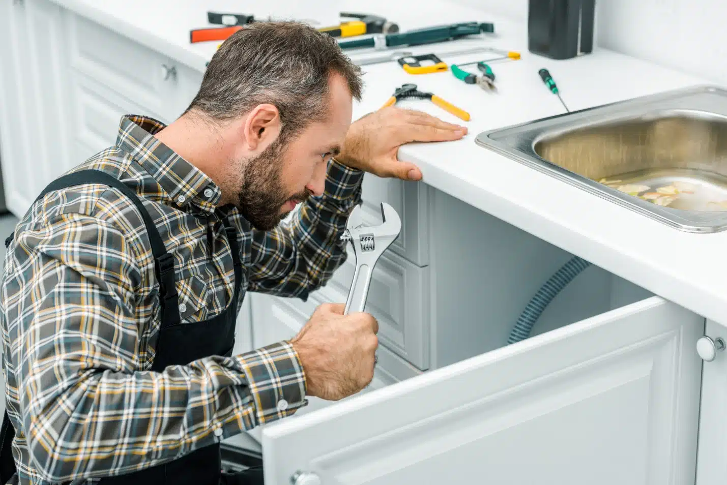 A person fixing a sink
AI-generated content may be incorrect.