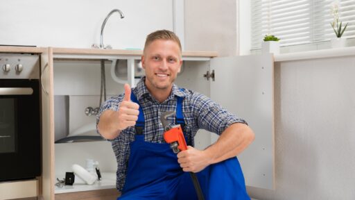 A person in blue overalls holding a wrench AI-generated content may be incorrect.