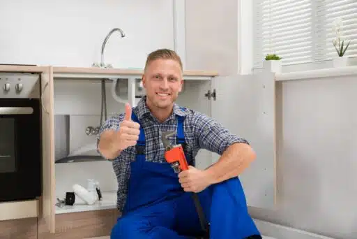 A person in blue overalls holding a wrench AI-generated content may be incorrect.