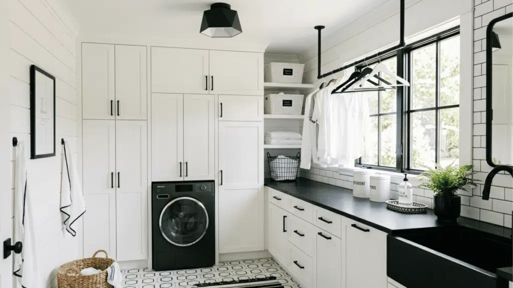 all-white laundry room with black accents, open shelves, and patterned floor. (2)