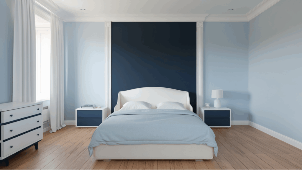 bedroom with soft blue walls, navy accent wall, and white furniture. (1)