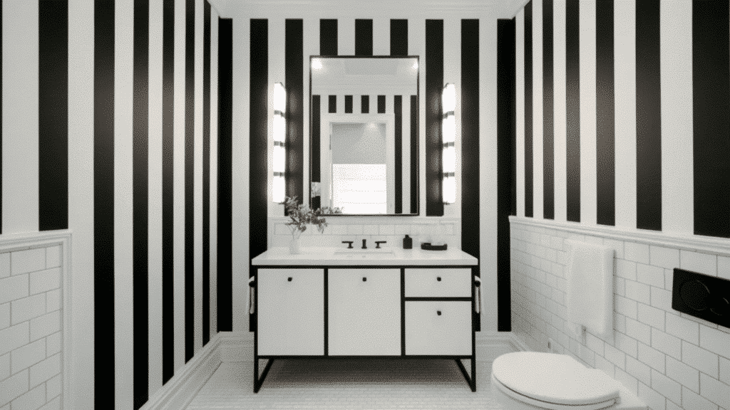 black and white bathroom with bold striped walls, modern vanity, and matte black fixtures creating a graphic modern design.