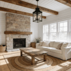 bright farmhouse living room with stone fireplace, shiplap walls, wood beams and cream sectional sofa