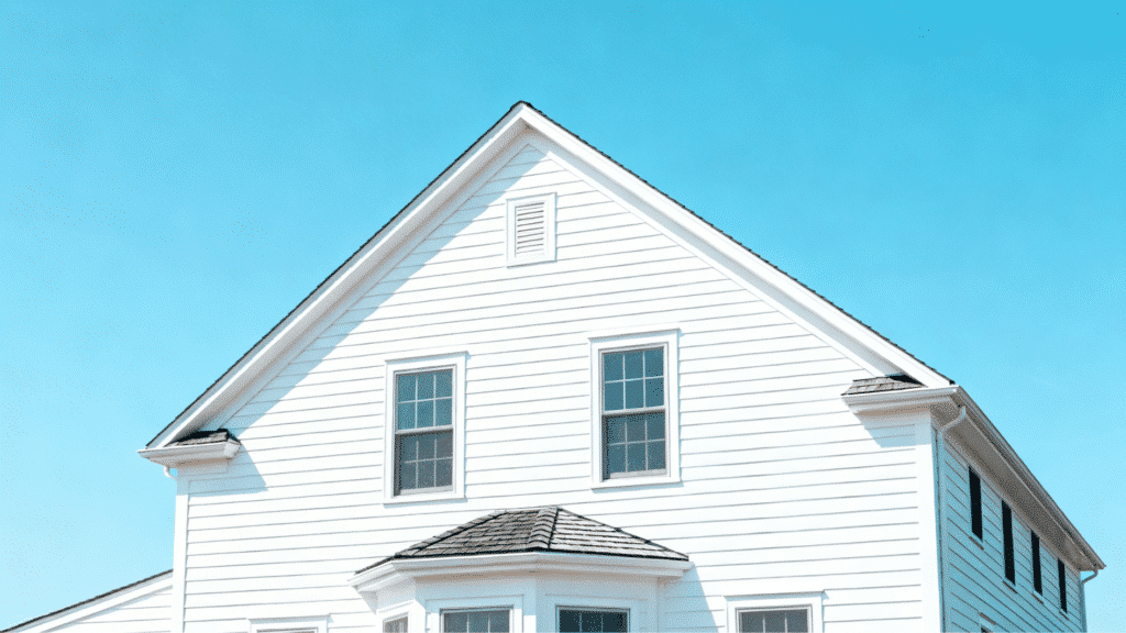 cape cod style house gable roof with white siding, dormer windows, and clean symmetrical coastal facade