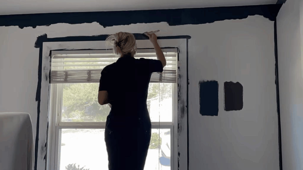 cutting in edges with angled brush along ceiling and trim