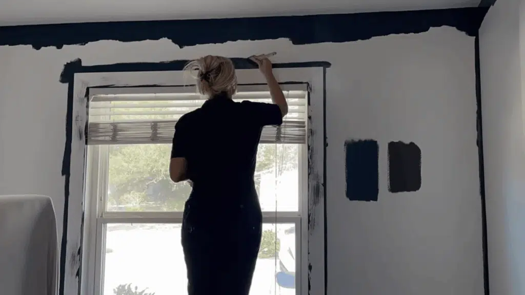 cutting in edges with angled brush along ceiling and trim