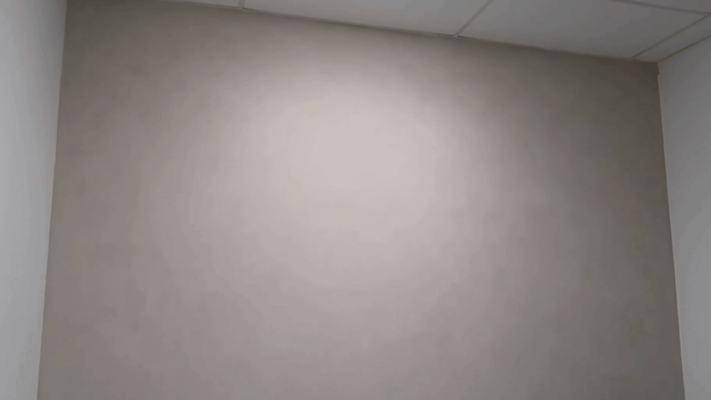 finished beige wall with soft textured paint effect, smooth blended tones creating subtle decorative finish in interior room