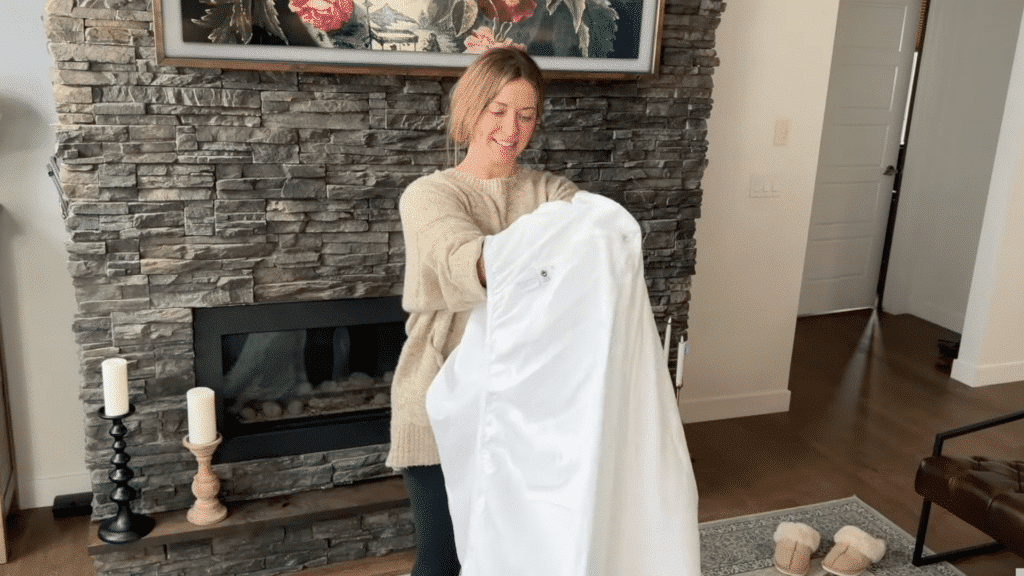 folding one corner over the other to create a pocket while holding the sheet up