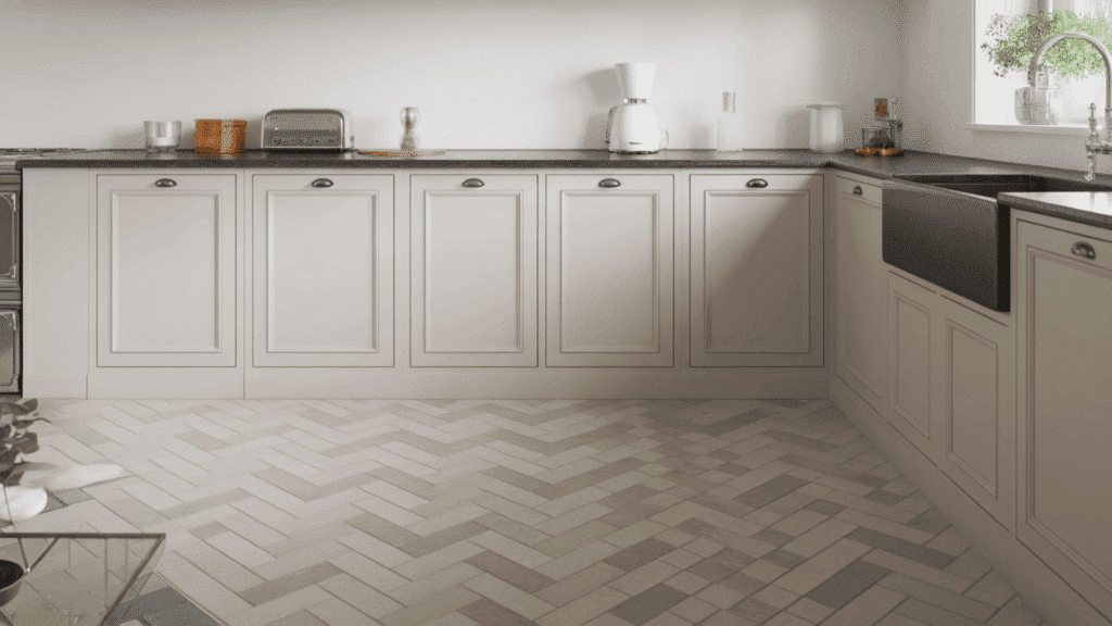herringbone tile floor and backsplash in a modern kitchen with white cabinets showing the pattern used in a high traffic practical space