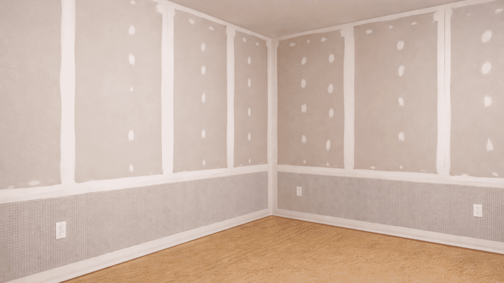 image showing drywall installation in a room with visible seams and edges, ready for finishing and painting, showcasing paperless drywall