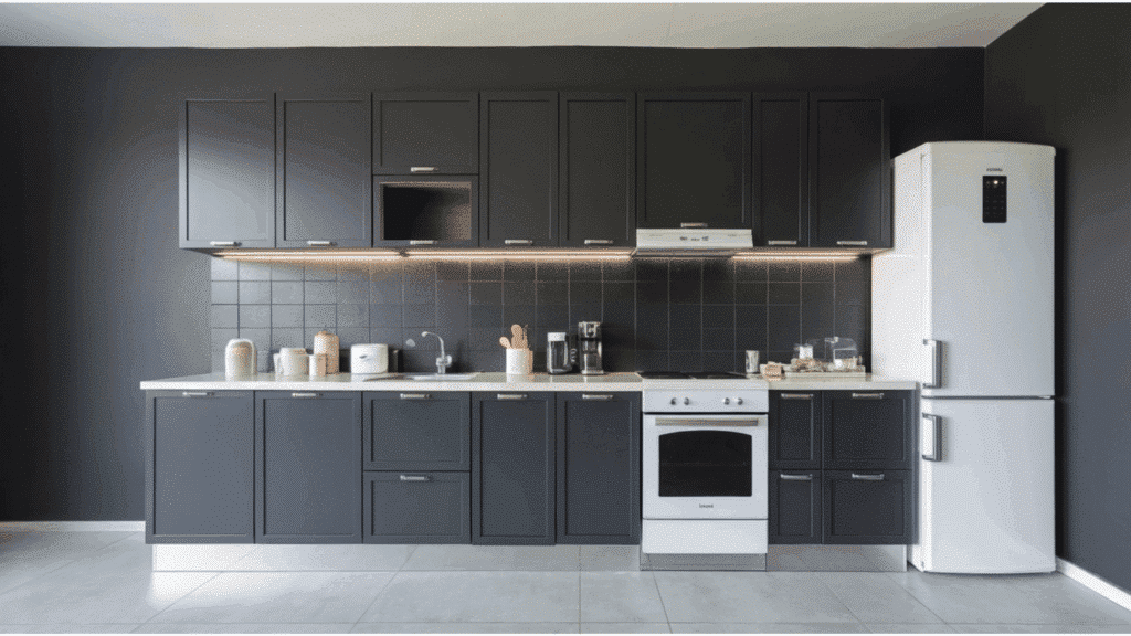 kitchen with dark gray cabinets, black backsplash, white fridge, and minimal decor.