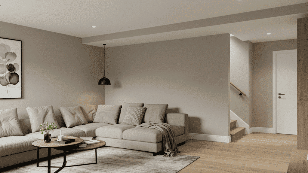 light greige basement walls with white trim, neutral sofa setup, wood flooring, and simple modern decor for a cozy space