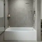 modern bathroom with alcove bathtub, glass shower, and wood vanity.