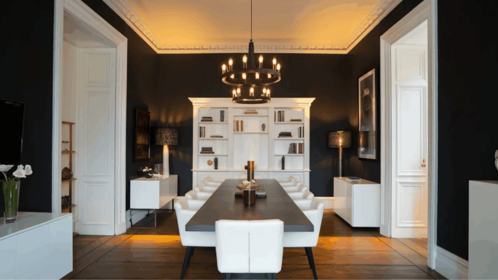 modern dining room with led lighting, warm ambient ceiling lights, dark walls, and minimal furniture setup