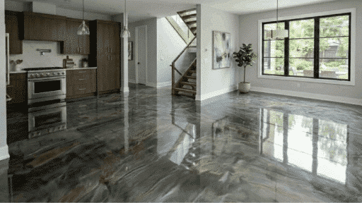 modern open-plan kitchen and living space with gloss marbled epoxy floor reflecting large windows and pendant lights air