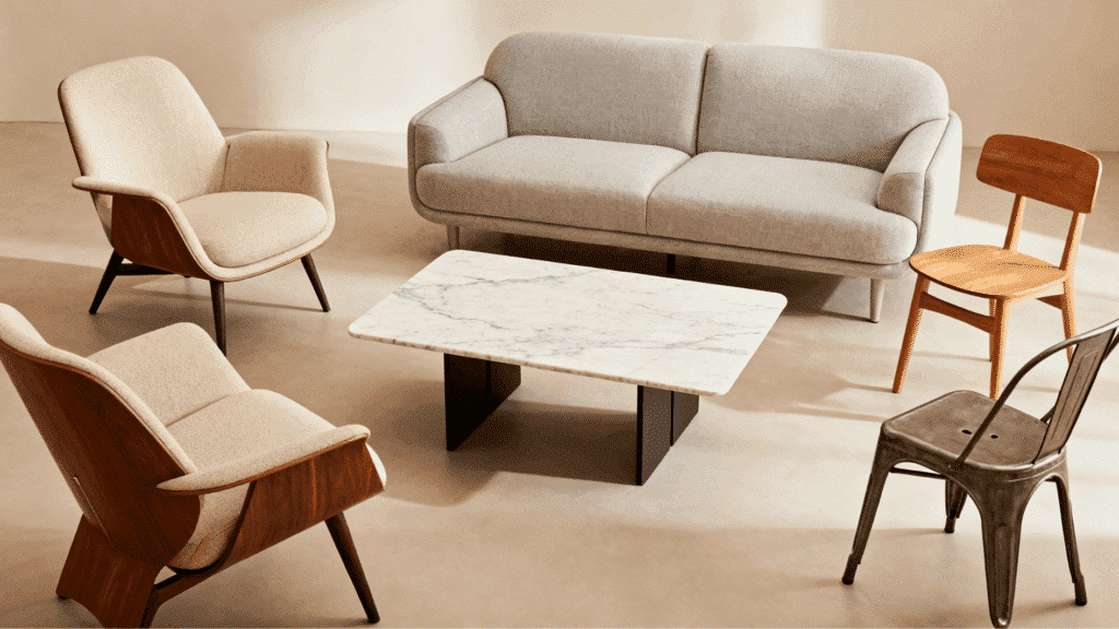 modern seating area with sofa, mixed chairs, and marble coffee table in a clean neutral interior setting