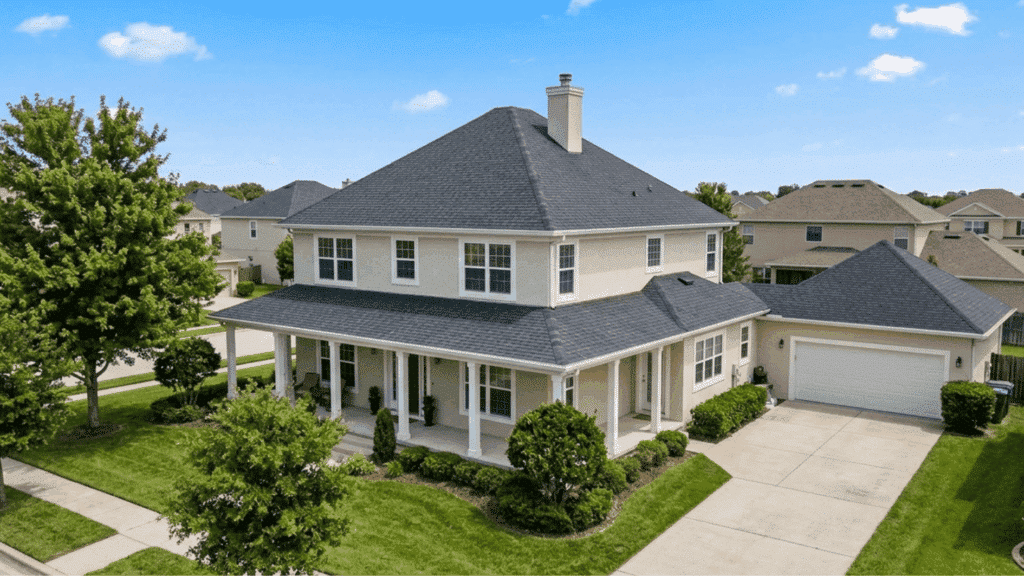 modern two story home with hip roof style, sloping sides and attached garage in suburb