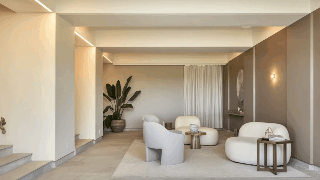 neutral beige basement walls with soft contrast trim, clean lines, minimal decor, and warm, balanced lighting in a calm space