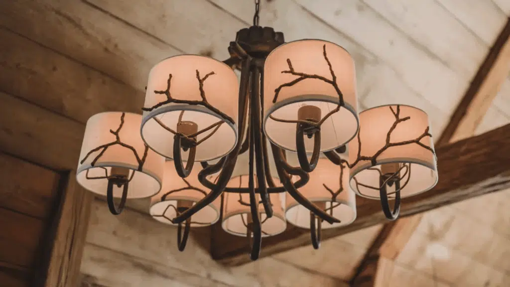 rustic chandelier with branch-like design and warm light fixtures