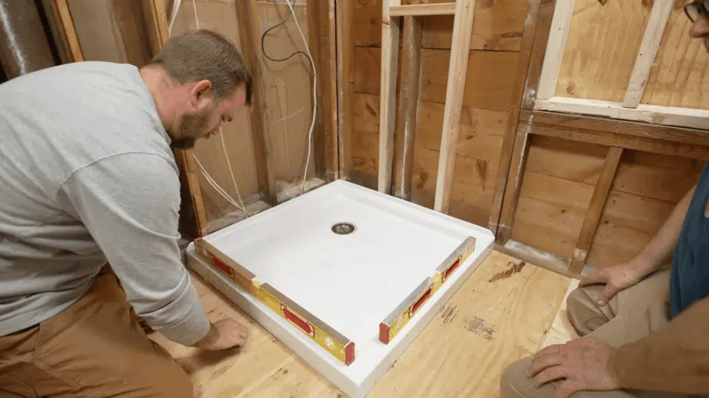 securing the shower pan into place