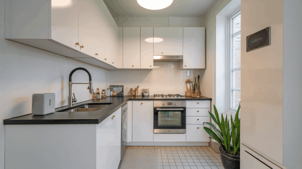 smart technology integration in a galley kitchen with touchless faucets and smart ovens.