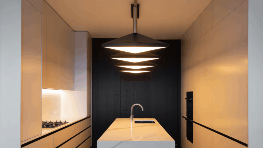 statement pendant lights in a galley kitchen adding style and visual interest.