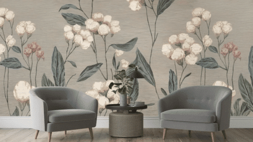 two gray armchairs with a small round table and plant set against a soft floral wallpaper background in a cozy room
