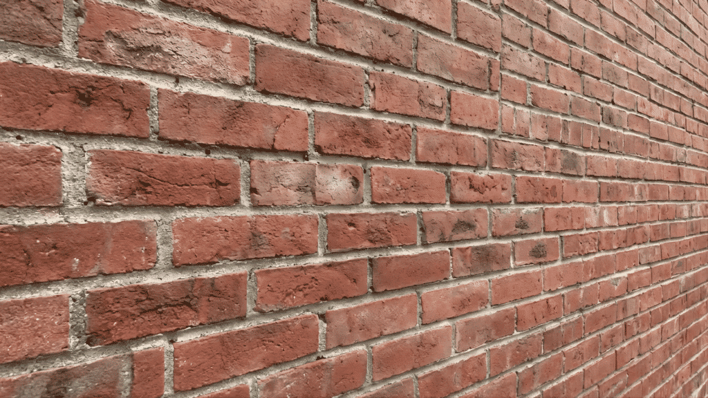 wide angle shot of a clean red brick wall with all paint removed to reveal the natural texture of the brick