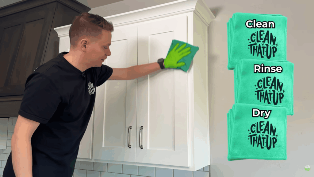 wiping painted cabinets using microfiber cloth and three towel method.